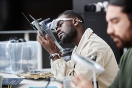 black-man-disassembling-drone-in-repair-shop-2023-12-19-19-59-33-utc